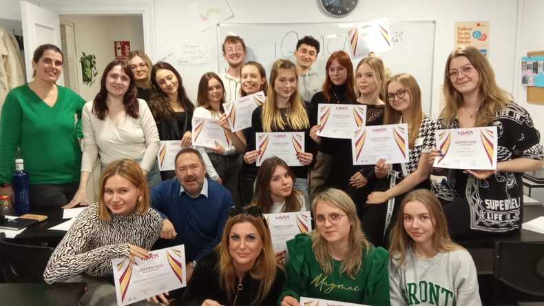 Happy students holding their certificates of completion