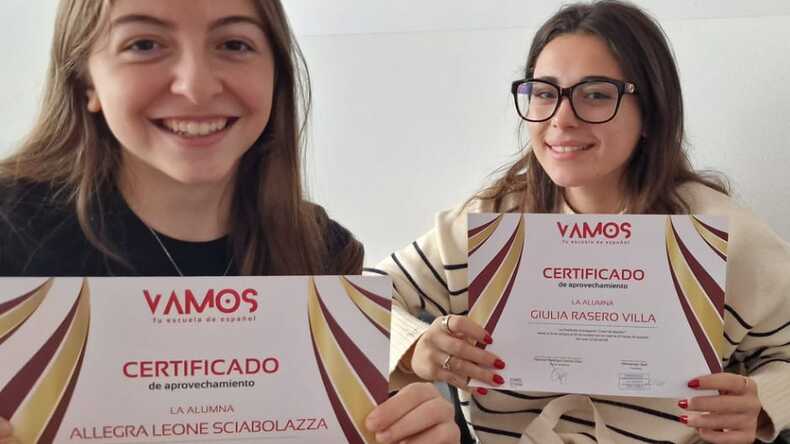 Happy students holding their certificates of completion